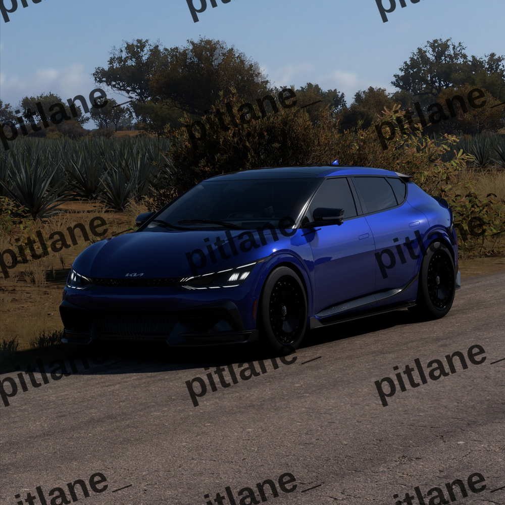 A blue compact SUV parked outdoors on a paved road with trees and shrubs in the background under a clear blue sky. The image has repeated 'pitlane_' watermarks and a 'Forz Motorsport' logo in the top right.
